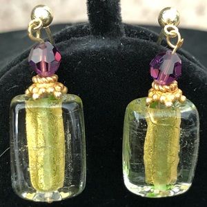 Purple and green/gold earrings in gold setting.
